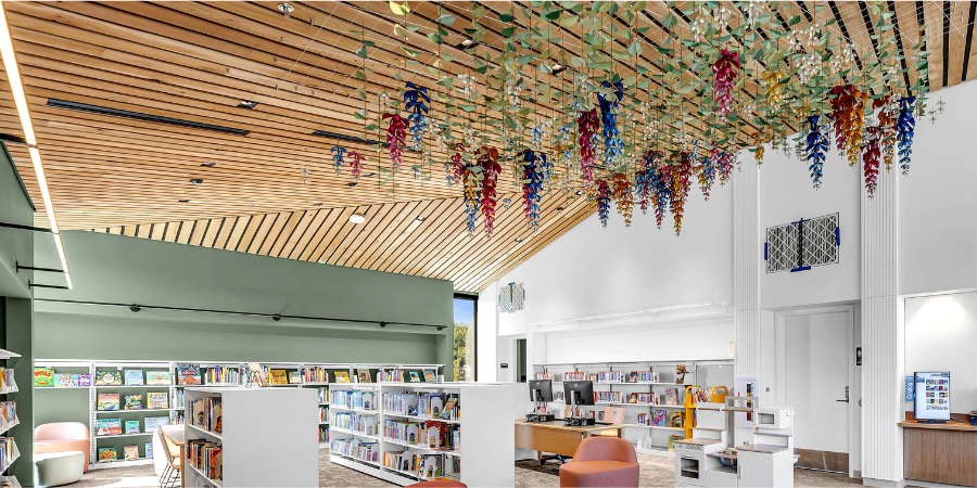 Phonic Bloom, the colorful paper flower sculpture, hangs above the children’s area at Woodland Community Library.