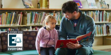 Father and young daughter reading