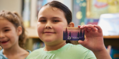 child holding library card