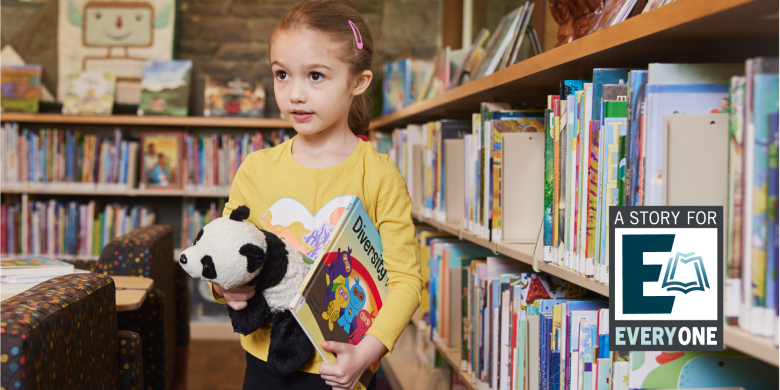 A young girl at the library holding a stuffed panda and a picture book