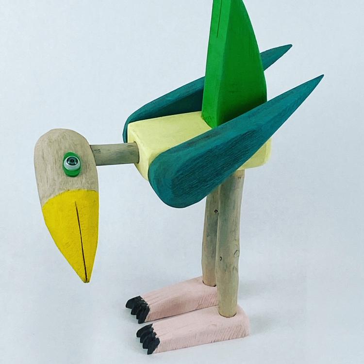 Dodo Bird Mother A sculpture of a green and yellow dodo bird with pink feet.