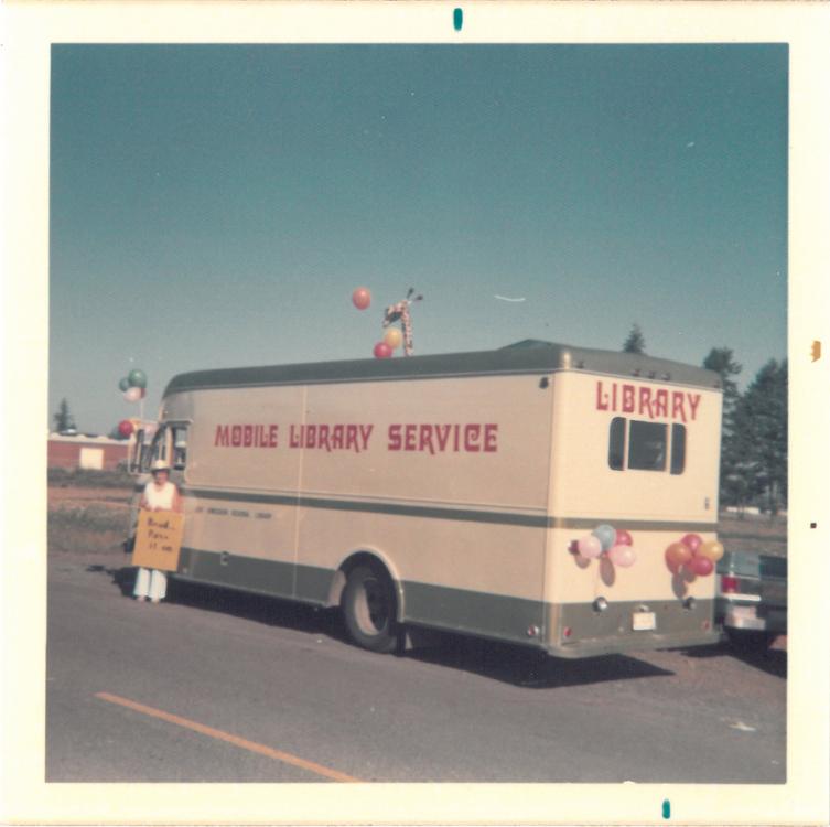Picture of a FVRlibraries bookmobile adorned with balloons and a toy giraffe, circa 1973