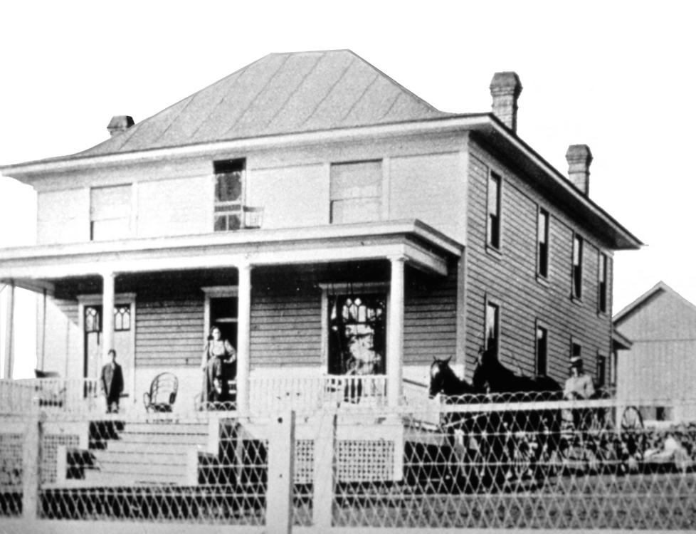 Black-and-white photo of La Center hospital building, repurposed into a library. The hospital was built in 1905.